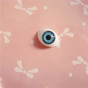 Macro detail of 10x14mm blue acrylic doll eye with radial iris texture for DIY dolls