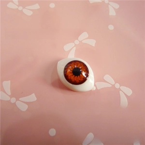 Close-up of 12x16mm acrylic doll eye with realistic brown iris and black pupil detail