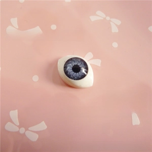 Detailed macro view of 12x16mm blue-grey acrylic doll eyes for toy making and crafts