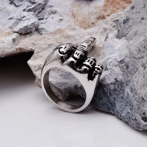 Silver stainless steel ring with a vintage middle finger gesture design on a rock base