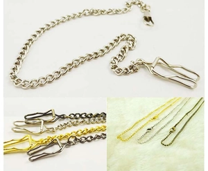 Detail view of retro pocket watch chains in silver, gold, and bronze with lobster clasps