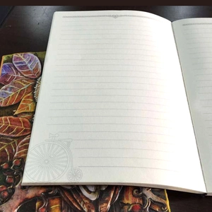 Close-up of vintage owl notebook with 3D embossed cover and lined beige paper