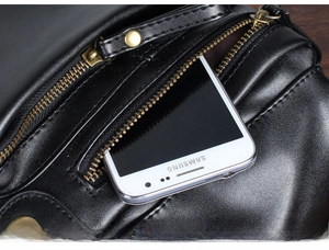 Detail view of the black PU leather messenger bag featuring a secure metal zipper pocket