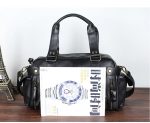 Large black PU leather travel bag shown with A4 magazine to demonstrate capacity