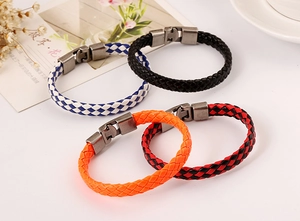 Detailed close-up of four woven leather bracelets with vintage silver metal hooks