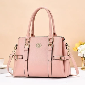 Detail view of pink lychee textured tote bag with golden metal logo and buckle decoration