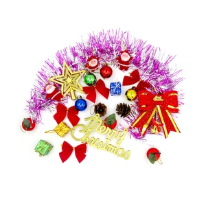 DIY Christmas wreath kit with purple tinsel, colorful ornaments, and Merry Christmas sign