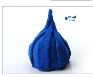 Detail of royal blue knitted hat showing vertical stripe texture and unique pointed top