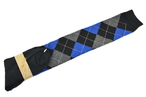 Detail of black argyle over-knee socks with blue and grey diamonds and paper tag