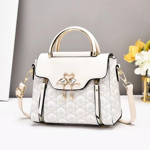 Elegant off-white crossbody bag with golden swan buckle and pearl detail for women