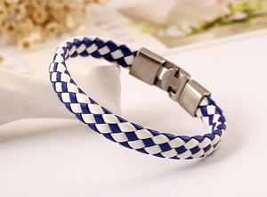 Close-up of blue and white braided leather bracelet with vintage bronze metal clasp