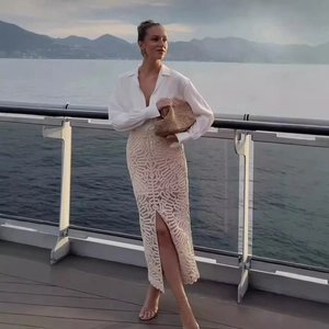 Elegant two-piece set with a white long-sleeve shirt and beige crochet knit midi skirt