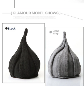 Detail view of thick knit pointy hats in black and light grey colors for winter season