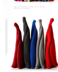 Detail of five colorful thick knit beanies showing ribbed texture and warm wool yarn
