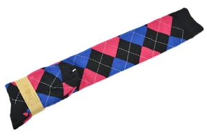 Detail of argyle pattern socks in pink blue and black with white stitching and packaging
