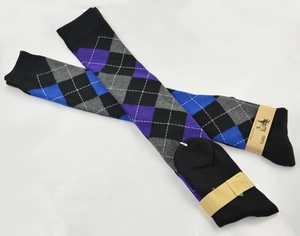 Close-up of argyle patterned over-knee socks in 100% cotton with brand packaging