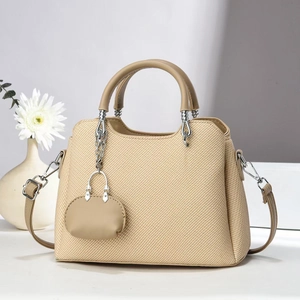 Beige woven handbag with brown leather handles and matching small pouch accessory