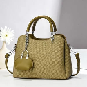 Detail of olive green woven texture shoulder bag with mini coin purse and silver chain