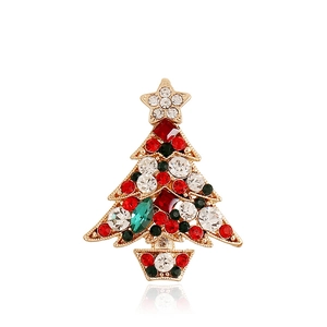 Detail shot of a golden Christmas tree brooch set with sparkling colorful rhinestones