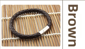 Close-up of woven brown leather cord bracelet with silver magnetic metal clasp on bamboo mat