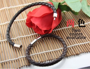Close-up of woven leather bracelets in black and brown with silver magnetic clasps