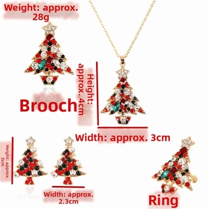 Detailed view of Christmas tree jewelry set with red and green crystals on gold alloy