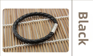 Detail of black braided leather bracelet for men featuring a silver magnetic clasp