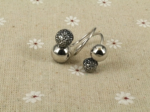 Macro view of gunmetal spiral ring featuring polished spheres and pavé grey crystals