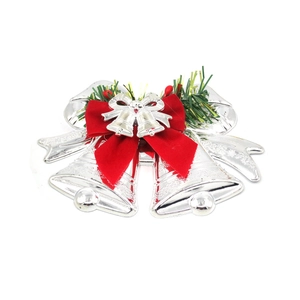 Silver Christmas bell ornaments with red velvet bow and pine needles for tree decor