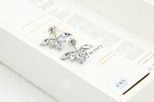 Macro shot of silver stud earrings with clear marquise cubic zirconia in a leaf fan design