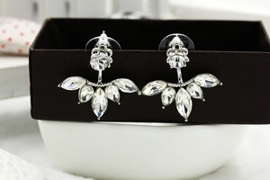 Detailed macro view of silver flower stud earrings featuring marquise-cut zircon petals