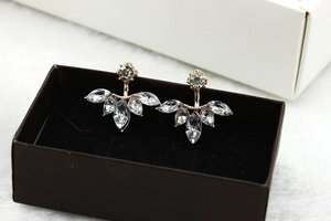 Macro shot of silver marquise zircon flower stud earrings in a black jewelry box