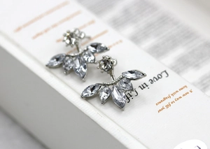 Macro shot of silver stud earrings with marquise-cut marquise zircon flower petals