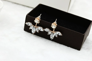 Detail of marquise-cut crystal earrings on a rose gold base in a jewelry box