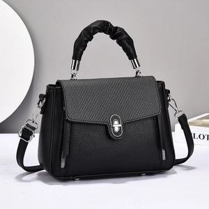 Black pebbled leather handbag with woven flap and silver twist-lock closure for women