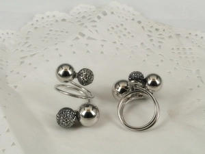 Detail of silver spiral ring with polished metal spheres and grey rhinestone pavé balls
