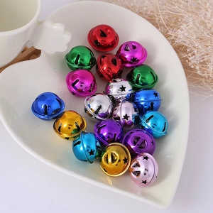 Colorful star-shaped metal bells in a heart-shaped tray for DIY crafts and decor