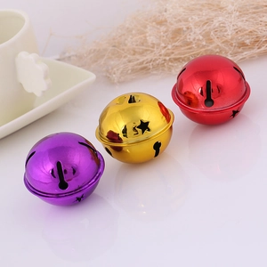 Close-up of purple gold and red star-patterned metal bells for DIY Christmas decor