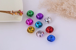 Close-up of assorted colorful hollow star-shaped metal bells for DIY crafts and decor