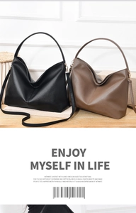 Detail of premium lychee texture leather on black and brown hobo tote bags with gold hardware