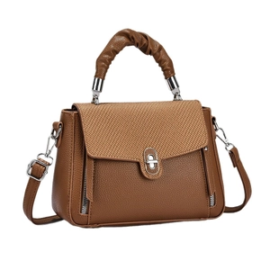 Brown crossbody handbag with woven texture flap and adjustable shoulder strap for women