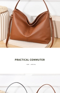 Detail of brown pebble grain leather hobo bag with adjustable strap in minimalist setting