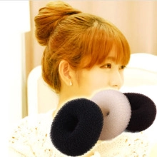 V-shaped hair straightener comb detail with black and brown sponge bun styling tool