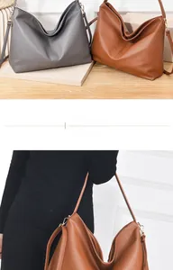 Detail of lychee pattern leather tote bag with detachable straps in grey and brown