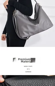 Detail view of grey textured PU leather tote bag with elegant gold-tone hardware buckles