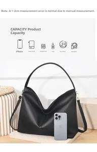 Macro view of black pebbled leather bucket bag showing spacious capacity and smooth texture