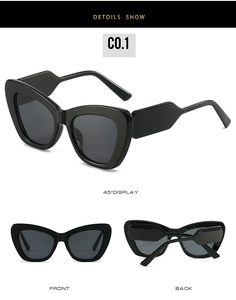 Detail view of black cat-eye sunglasses with thick wave-shaped temples and dark lenses