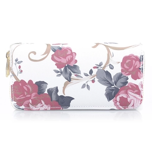 Detail of white long zip wallet featuring red rose prints and gold metal hardware