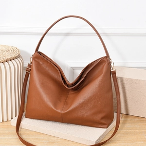 Caramel brown pebbled leather bucket bag for women with dual straps and gold hardware