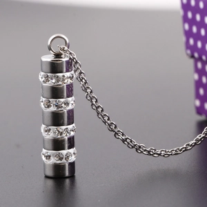 Polished stainless steel cylinder necklace featuring four rows of sparkling white crystals